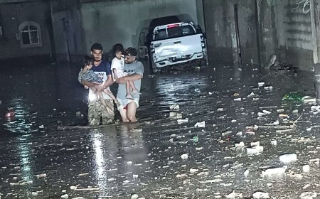 أبوان يحملان أطفالهما على الأكتاف هربًا من مياه السيول في عدن